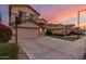 Beautiful two-story home showcasing a lush landscaped front yard, wide driveway, and an attached two-car garage at 17541 W Statler Dr, Surprise, AZ 85388