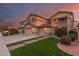 Stunning two-story home boasting a well-maintained front yard, three-car garage, and inviting entrance at 17541 W Statler Dr, Surprise, AZ 85388