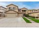 Charming home showcasing a lush landscaped front yard, wide driveway, and an attached two-car garage at 17541 W Statler Dr, Surprise, AZ 85388