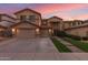 Charming two-story home featuring a well-manicured lawn and a spacious three-car garage with inviting curb appeal at 17541 W Statler Dr, Surprise, AZ 85388