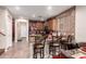 Modern kitchen with granite counters, wooden cabinets, tile backsplash, and barstool seating at 17541 W Statler Dr, Surprise, AZ 85388