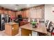 Well-lit kitchen with granite countertops, stainless steel appliances, and an eye-catching tile backsplash at 17541 W Statler Dr, Surprise, AZ 85388