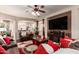 Living room with modern decor, including a large sectional, flatscreen TV and an archway to dining area at 17541 W Statler Dr, Surprise, AZ 85388