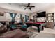 Spacious living room with comfortable seating, a billiards table and a large television providing ample entertainment options at 17541 W Statler Dr, Surprise, AZ 85388