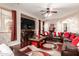 Comfortable living room with large television, fireplace, comfortable seating, and archway access at 17541 W Statler Dr, Surprise, AZ 85388