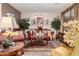 Elegant living room with a decorative area rug, comfortable seating, and decorative plants at 17541 W Statler Dr, Surprise, AZ 85388