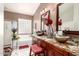 Luxurious main bathroom with double sinks, granite countertops, stylish decor and separate tub and shower at 17541 W Statler Dr, Surprise, AZ 85388