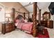 Beautiful main bedroom with a grand four-poster bed, detailed furnishings, and warm lighting at 17541 W Statler Dr, Surprise, AZ 85388
