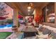 Covered patio with cozy seating, decorative pillows, and a view of the pool and landscaped yard at 17541 W Statler Dr, Surprise, AZ 85388