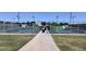 Community pickleball courts with green fencing and well-maintained green grass at 17541 W Statler Dr, Surprise, AZ 85388