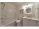 Clean bathroom featuring a shower-tub combo and ample vanity storage space at 1763 W Pepper Pl, Mesa, AZ 85201