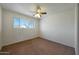 Bedroom with a ceiling fan, carpet floors and bright window at 1763 W Pepper Pl, Mesa, AZ 85201