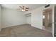 Bright bedroom featuring a ceiling fan and closet with views to other rooms at 1763 W Pepper Pl, Mesa, AZ 85201