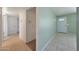 Hallway view with neutral walls and tile flooring leading to the front door at 1763 W Pepper Pl, Mesa, AZ 85201