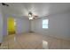 Living room area with tile floors and views to another room and the entrance at 1763 W Pepper Pl, Mesa, AZ 85201