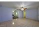 Inviting living room with tile flooring, ceiling fan, and open access to the kitchen area at 1763 W Pepper Pl, Mesa, AZ 85201