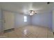 Bright and airy living room featuring neutral walls, tile flooring, and a front door entrance at 1763 W Pepper Pl, Mesa, AZ 85201