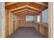 Storage shed interior featuring wood framing, shelving, a window, and ample open space at 1763 W Pepper Pl, Mesa, AZ 85201