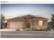 Charming home featuring a well-manicured front yard, desert landscaping, and a two-car garage at 17656 W Rancho Dr, Litchfield Park, AZ 85340