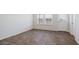 Bright room with hardwood flooring, neutral walls, and natural light from the windows at 1828 W Sheridan Ave, Apache Junction, AZ 85120