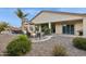 Spacious backyard with fire pit, covered patios, hot tub, and mature landscaping, perfect for entertaining at 18324 W Highland Ave, Goodyear, AZ 85395