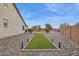 Expansive backyard with artificial turf, rock landscaping, and views of the pool and outdoor living areas at 18324 W Highland Ave, Goodyear, AZ 85395