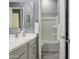 Bathroom featuring double vanity with modern fixtures, and a separate room with a toilet and shower/tub at 18324 W Highland Ave, Goodyear, AZ 85395