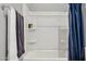 Bathroom view highlighting the tub and shower featuring a blue shower curtain at 18324 W Highland Ave, Goodyear, AZ 85395