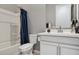 Bathroom features a tub/shower combo with blue curtains and a white vanity at 18324 W Highland Ave, Goodyear, AZ 85395