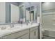 Bathroom featuring double vanity with modern fixtures, and a separate room with a toilet and shower/tub at 18324 W Highland Ave, Goodyear, AZ 85395