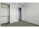 Bright bedroom featuring a closet, neutral walls, carpeted floor, and a doorway at 18324 W Highland Ave, Goodyear, AZ 85395