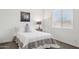 Cozy bedroom featuring a comfortable twin bed, neutral decor and a large window providing ample natural light at 18324 W Highland Ave, Goodyear, AZ 85395