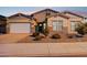 Charming single-Gathering home showcasing a well-maintained lawn and a three-car garage at 18324 W Highland Ave, Goodyear, AZ 85395
