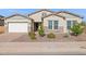 Charming home with manicured front yard and stone accents offers curb appeal at 18324 W Highland Ave, Goodyear, AZ 85395