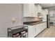 Modern kitchen showcasing white cabinets, dark countertops, and sleek appliances at 18324 W Highland Ave, Goodyear, AZ 85395