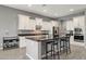 Modern kitchen boasts granite countertops and sleek white cabinetry, a chef's dream at 18324 W Highland Ave, Goodyear, AZ 85395