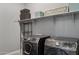 Modern laundry room with Samsung washer and dryer and ample shelving for storage and organization at 18324 W Highland Ave, Goodyear, AZ 85395