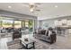 Spacious living room with tile floors, neutral décor, and access to outdoor patio at 18324 W Highland Ave, Goodyear, AZ 85395