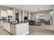 Open concept living space with grey walls, tile flooring, and a comfortable sofa at 18324 W Highland Ave, Goodyear, AZ 85395