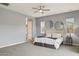 Inviting bedroom with natural light, mirrored decor, and a plush bed, perfect for rest at 18324 W Highland Ave, Goodyear, AZ 85395