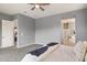 Spacious primary bedroom featuring soft natural light, neutral decor and an open entrance to the primary bathroom at 18324 W Highland Ave, Goodyear, AZ 85395