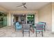 Covered patio featuring comfortable seating with blue cushions and a ceiling fan for outdoor enjoyment at 18324 W Highland Ave, Goodyear, AZ 85395