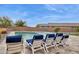 Inviting backyard pool area with lounge chairs, umbrellas, and lush landscaping for ultimate relaxation at 18324 W Highland Ave, Goodyear, AZ 85395