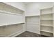 Spacious walk-in closet providing ample storage with built-in shelving and hanging rods at 18324 W Highland Ave, Goodyear, AZ 85395
