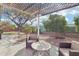 Outdoor space with a patio set, shade structure, and mature trees for a relaxing atmosphere at 18327 N Summerbreeze Way, Surprise, AZ 85374