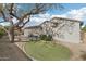 Spacious backyard with desert landscaping, artificial turf area, and mature trees for a low-maintenance outdoor space at 18327 N Summerbreeze Way, Surprise, AZ 85374