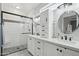 Modern bathroom showcasing double sinks, white cabinets, and a walk-in shower with glass door at 18327 N Summerbreeze Way, Surprise, AZ 85374