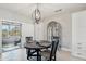 Bright dining area featuring a modern chandelier, stylish furniture, and access to the outdoor space at 18327 N Summerbreeze Way, Surprise, AZ 85374