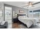 Serene main bedroom with a ceiling fan, ensuite bathroom, and a large window for natural light at 18327 N Summerbreeze Way, Surprise, AZ 85374