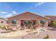 Expansive backyard featuring a cozy fire pit, lounge area, and low-maintenance desert landscaping at 19932 N Ibis Way, Maricopa, AZ 85138